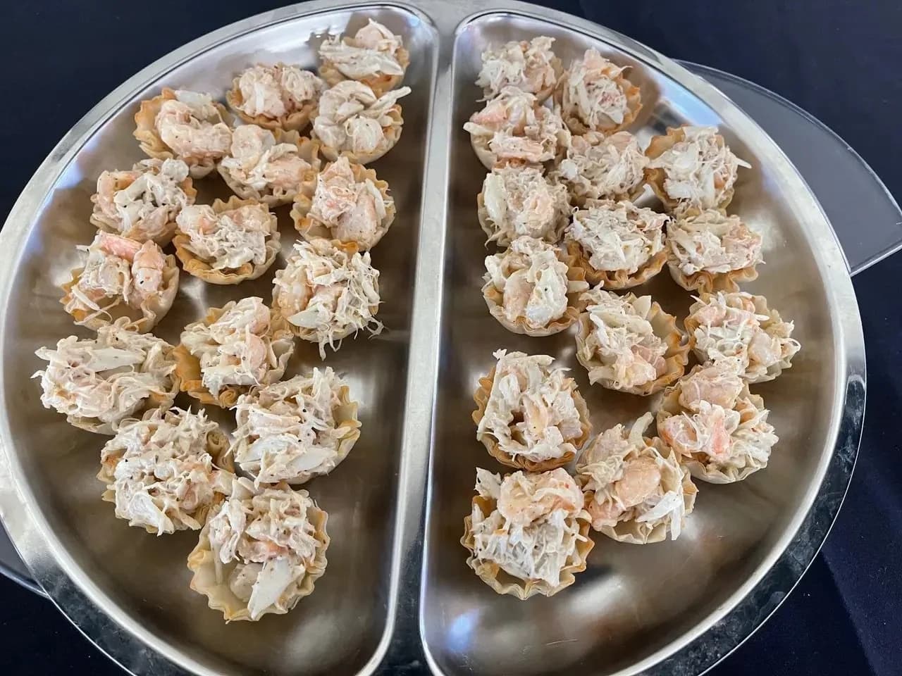 Prepared crab-salad wonton cups arranged on a serving tray.