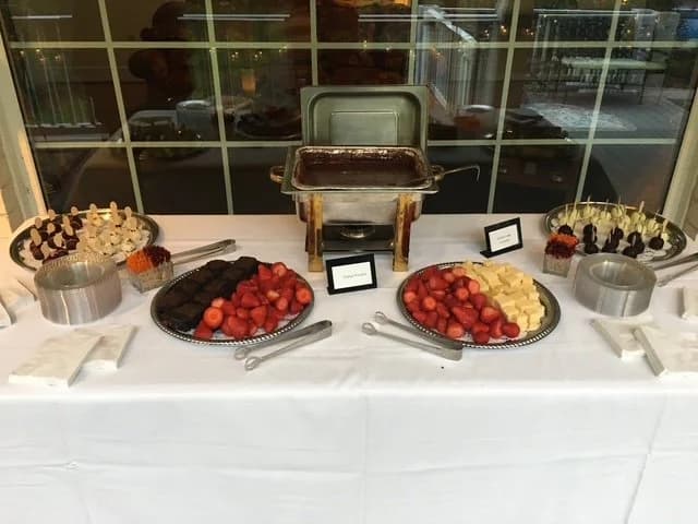 A dessert buffet with chocolate, strawberry, and cheesecake selections.