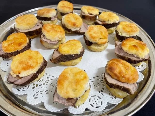 Small sliced-meat appetizers topped with mashed potatoes and browned cheese.